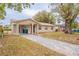 A cozy single-story home with a covered carport and a long driveway leading up to the front entrance at 1335 Lescot Ln, Orlando, FL 32811