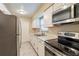 Well-equipped kitchen featuring stainless steel appliances, ample counter space, and white cabinetry for a clean aesthetic at 1335 Lescot Ln, Orlando, FL 32811