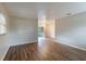 Open living room featuring sleek hardwood floors, fresh paint, and ample natural light from the windows at 1335 Lescot Ln, Orlando, FL 32811