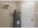 Utility area featuring a hot water heater, shelving and access to other parts of the home at 1335 Lescot Ln, Orlando, FL 32811