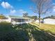 Large backyard with grassy area and screened porch at 1375 Sacramento St, Deltona, FL 32725