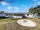 Spacious backyard with a screened patio and fire pit area at 1375 Sacramento St, Deltona, FL 32725