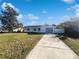 Newly renovated home with a large front yard and driveway at 1375 Sacramento St, Deltona, FL 32725