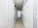Clean hallway with tile flooring and doors to rooms at 1375 Sacramento St, Deltona, FL 32725