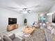 Bright living room featuring comfortable seating and a large TV at 1375 Sacramento St, Deltona, FL 32725