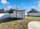 Metal storage shed in the backyard with a roll-up door at 1375 Sacramento St, Deltona, FL 32725