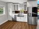 Modern kitchen with white cabinets, stainless steel appliances, and a farmhouse sink at 14421 Parker Rd, Orlando, FL 32832