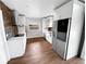 Modern kitchen with white cabinets, stainless steel appliances, and wood backsplash at 14421 Parker Rd, Orlando, FL 32832