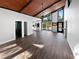 Bright living room with vaulted ceiling, hardwood floors, and sliding doors leading to the pool at 14421 Parker Rd, Orlando, FL 32832