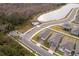 Aerial view of neighborhood with houses, roads, and a pond at 1550 Outback Rd, St Cloud, FL 34771