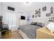Second bedroom with a queen-size bed, dresser, and stylish decor at 1550 Outback Rd, St Cloud, FL 34771