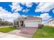 House exterior with stone accents, white garage door, and landscaping at 1550 Outback Rd, St Cloud, FL 34771