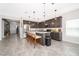Open kitchen with island, granite counters, and stainless steel appliances at 1550 Outback Rd, St Cloud, FL 34771