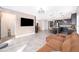 Open living room showcasing a spacious layout, leather sectional sofa, and kitchen views at 1550 Outback Rd, St Cloud, FL 34771