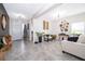 Open living room with neutral decor and access to other rooms at 1550 Outback Rd, St Cloud, FL 34771