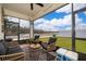 Relaxing screened porch with wicker furniture and view of yard at 1550 Outback Rd, St Cloud, FL 34771
