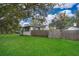 Large backyard with wooden fence and lush green grass at 1601 New York Ave., St Cloud, FL 34769