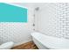 White subway tile, a clawfoot tub, and a walk-in shower at 1601 New York Ave., St Cloud, FL 34769