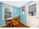 Small dining area with light blue walls and wooden table and chairs at 1601 New York Ave., St Cloud, FL 34769