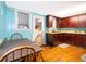 Small dining area with light blue walls and wooden table and chairs at 1601 New York Ave., St Cloud, FL 34769
