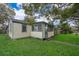 Charming yellow house with green trim, spacious yard, and mature trees at 1601 New York Ave., St Cloud, FL 34769