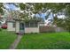 Charming single-story house with a green door and yard at 1601 New York Ave., St Cloud, FL 34769