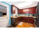 Dark wood kitchen cabinets, blue backsplash, stainless steel appliances at 1601 New York Ave., St Cloud, FL 34769
