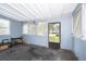 Sunroom with wood floors, multiple windows, and storage at 1601 New York Ave., St Cloud, FL 34769