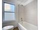 Simple bathroom with a tub, shower, and wood-look flooring at 17 S Oleander Ave, Daytona Beach, FL 32118