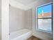 Updated bathroom with a tub and shower, and wood-look flooring at 17 S Oleander Ave, Daytona Beach, FL 32118