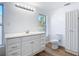 Updated bathroom with white vanity, toilet, and linen closet at 17 S Oleander Ave, Daytona Beach, FL 32118