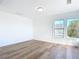 Bright bedroom with hardwood floors and a window at 17 S Oleander Ave, Daytona Beach, FL 32118