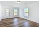 Well-lit bedroom with hardwood floors and two windows at 17 S Oleander Ave, Daytona Beach, FL 32118