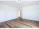 Simple bedroom with hardwood floors and door to bathroom at 17 S Oleander Ave, Daytona Beach, FL 32118