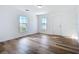 Simple bedroom with hardwood floors and two windows at 17 S Oleander Ave, Daytona Beach, FL 32118