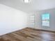 Bright bedroom with hardwood floors and a window at 17 S Oleander Ave, Daytona Beach, FL 32118