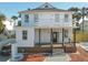 Two-story house with white exterior, brown deck, and black accents at 17 S Oleander Ave, Daytona Beach, FL 32118