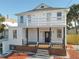 Two-story house with white exterior, brown deck, and black accents at 17 S Oleander Ave, Daytona Beach, FL 32118