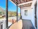 Front porch with wooden deck, black railings, and wood ceiling at 17 S Oleander Ave, Daytona Beach, FL 32118