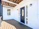 Front porch with black door and wooden deck at 17 S Oleander Ave, Daytona Beach, FL 32118