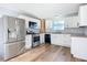 Modern kitchen with white cabinets, granite counters, and stainless steel appliances at 17 S Oleander Ave, Daytona Beach, FL 32118