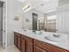 Double vanity bathroom with large mirror and shower at 1808 Sandy Park Trl, Kissimmee, FL 34747