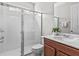 Clean bathroom with shower, toilet and brown vanity at 1808 Sandy Park Trl, Kissimmee, FL 34747