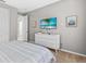 Bedroom with dresser, TV, and view into hallway at 1808 Sandy Park Trl, Kissimmee, FL 34747