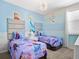 Charming bedroom with twin beds, Frozen-themed decor, and window coverings at 1808 Sandy Park Trl, Kissimmee, FL 34747