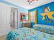 Toy Story themed bedroom with twin beds, dresser, and access to other rooms at 1808 Sandy Park Trl, Kissimmee, FL 34747