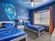 Avatar themed bedroom with twin beds and mural at 1808 Sandy Park Trl, Kissimmee, FL 34747