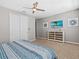 Primary bedroom with large bed, dresser, and ceiling fan at 1808 Sandy Park Trl, Kissimmee, FL 34747