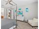 Bedroom with dresser, TV, and view into bathroom at 1808 Sandy Park Trl, Kissimmee, FL 34747