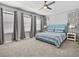 Spacious Primary bedroom with a large bed, carpet, and ceiling fan at 1808 Sandy Park Trl, Kissimmee, FL 34747